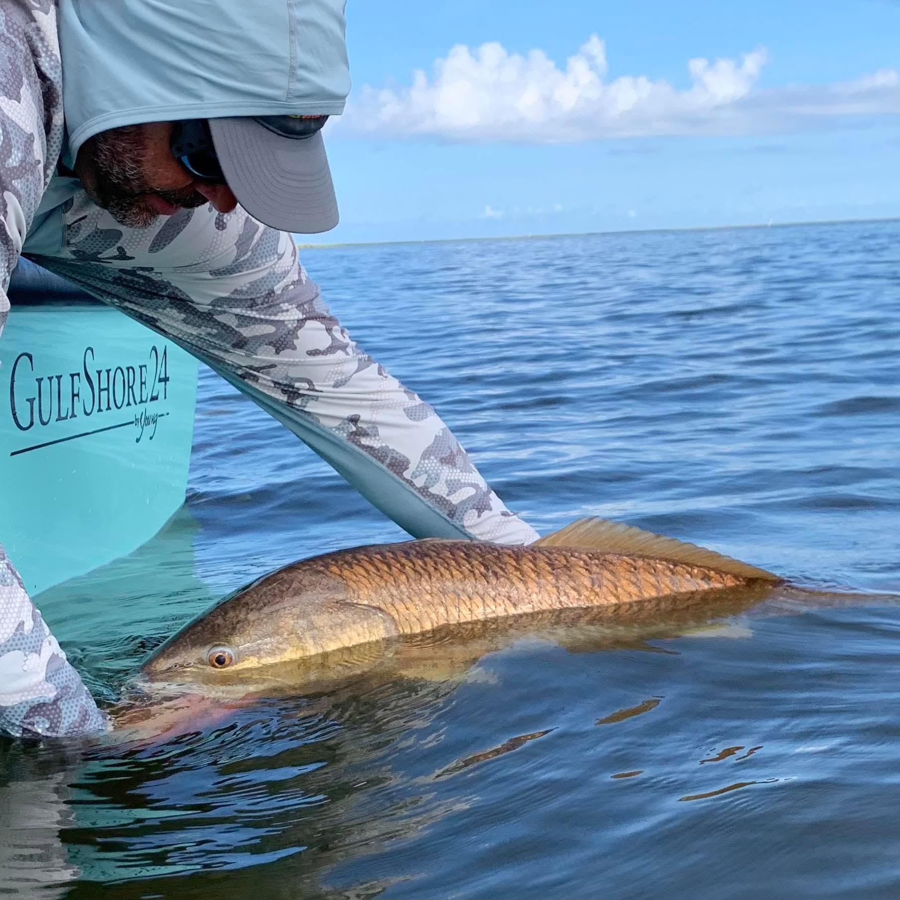 Releasing a redfish beside the boat in Barataria Bay