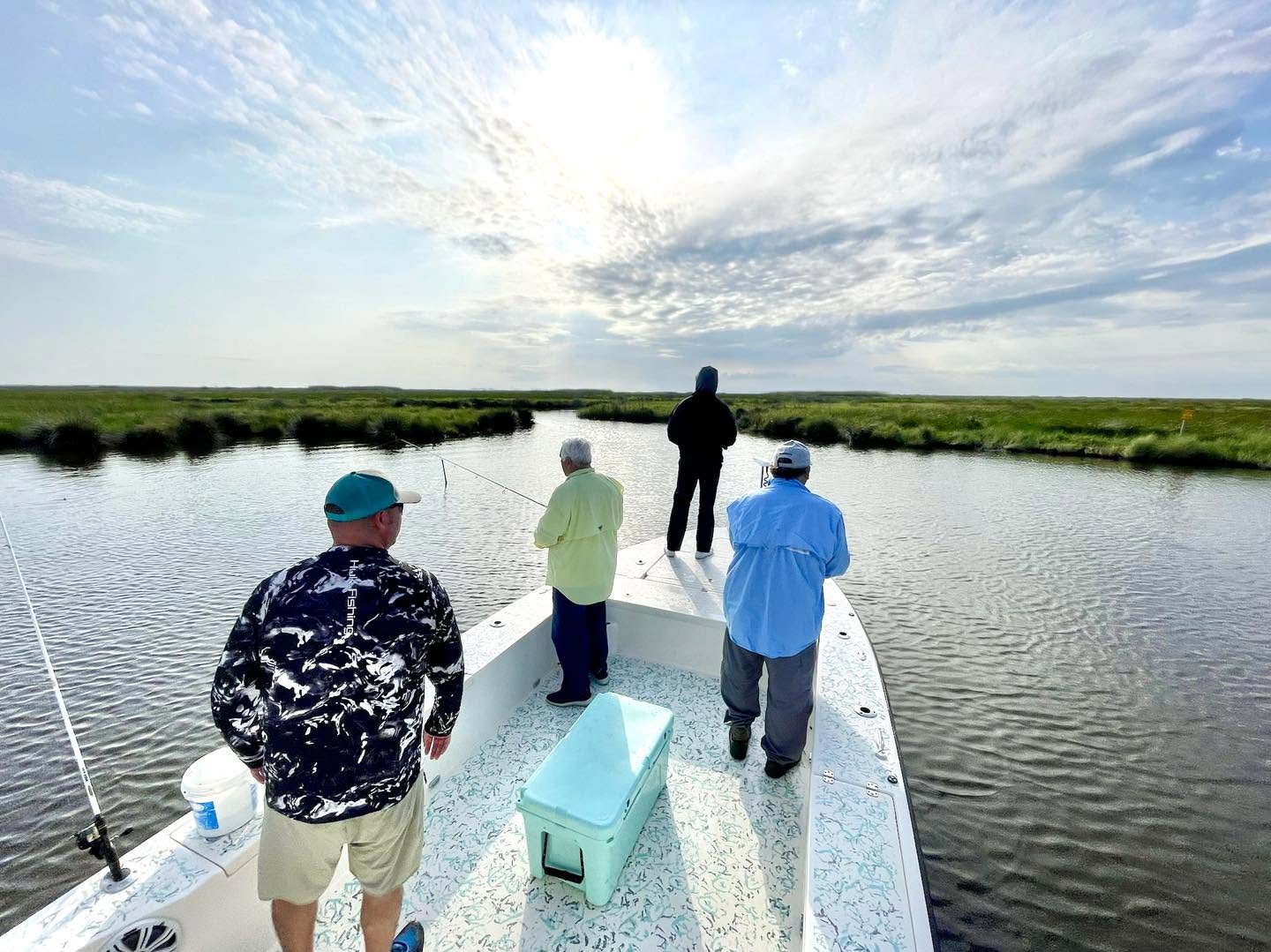 Anglers casting from the bow of a boat in a Barataria marsh bayou